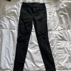 AMERICAN EAGLE- Black skinny stretchy jeans with knee rips.